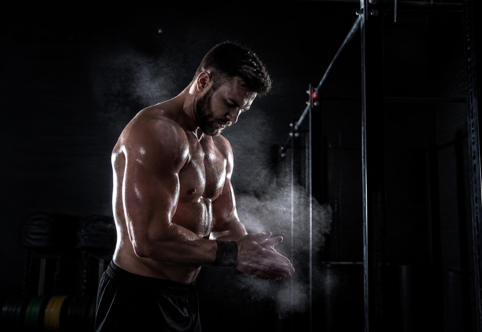 Determined man training in a dark gym
